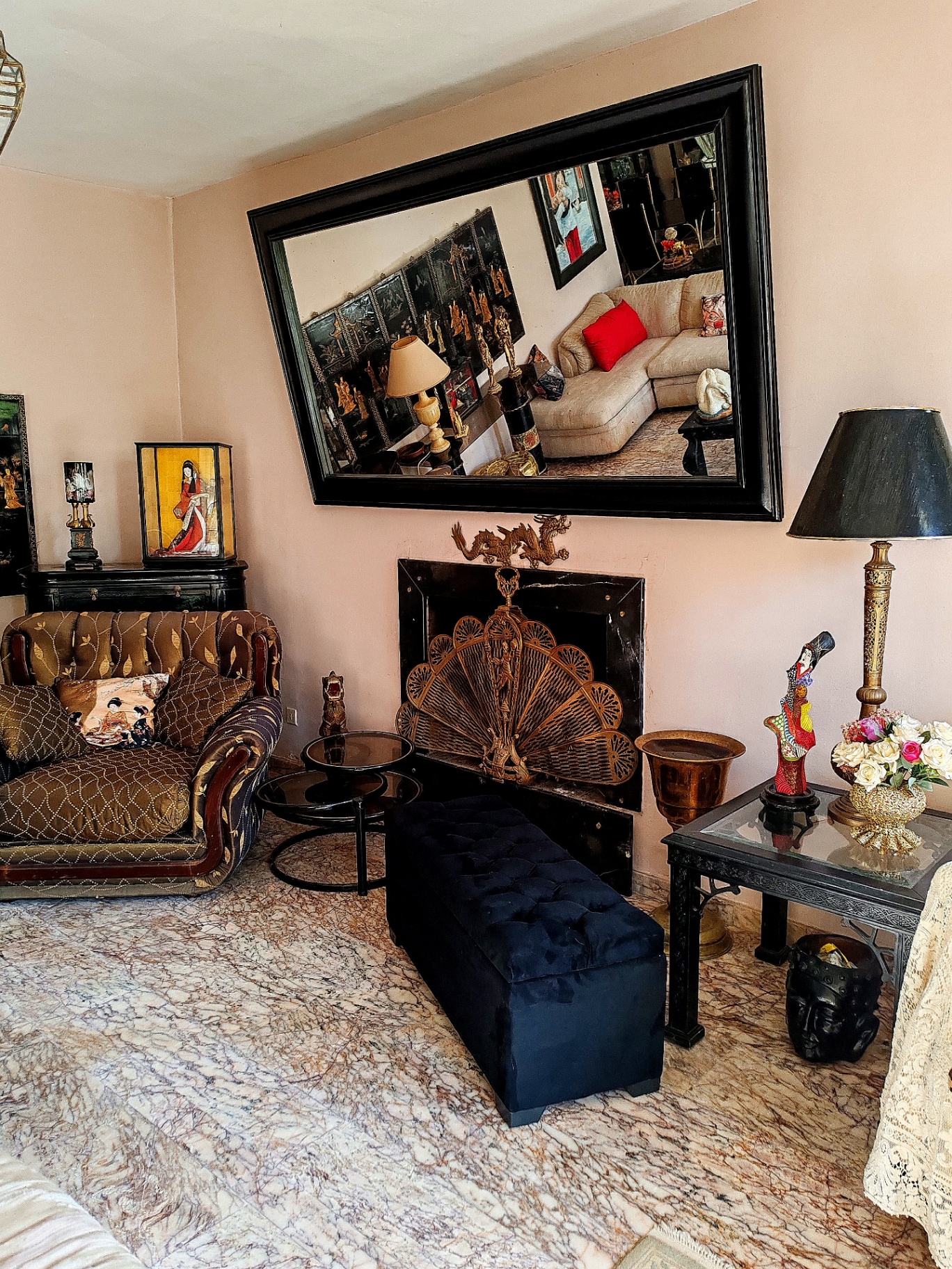 Fireplace with a mirror above it, in the first-floor salon